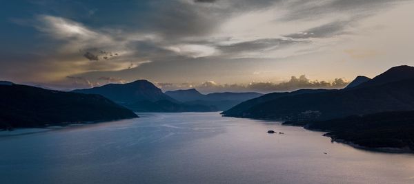 Scenic view of silhouette mountains against sky at sunset