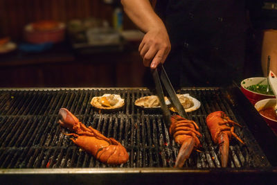 Man preparing food on barbecue grill