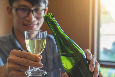 Close-up of woman holding wine glass