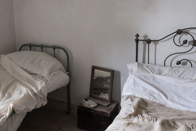 Electric lamp on bed against wall at home
