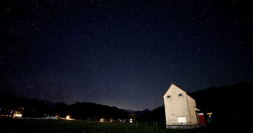 Low angle view of illuminated buildings against sky at night