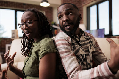 Portrait of smiling friends sitting at restaurant