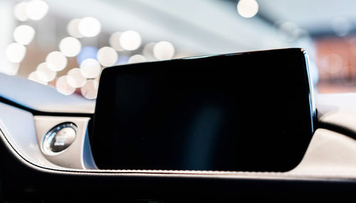 Close-up of mobile phone on dashboard of car