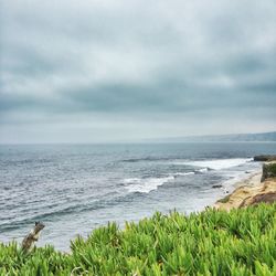 Scenic view of sea against cloudy sky