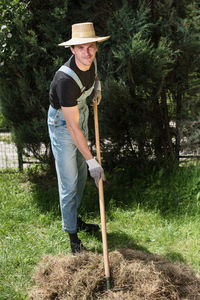 Portrait of farmer working with rake in garden