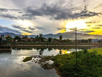 Scenic view of river against cloudy sky