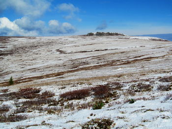 Scenic view of land against sky during winter