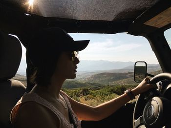 Portrait of man seen through car window