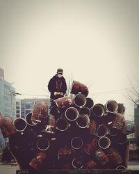 Man in city against sky