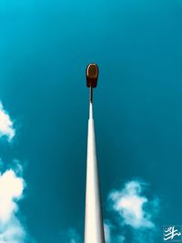 Low angle view of street light against blue sky