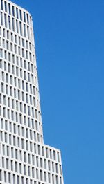 Low angle view of modern building against clear blue sky