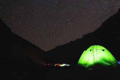 Scenic view of illuminated mountain against sky at night