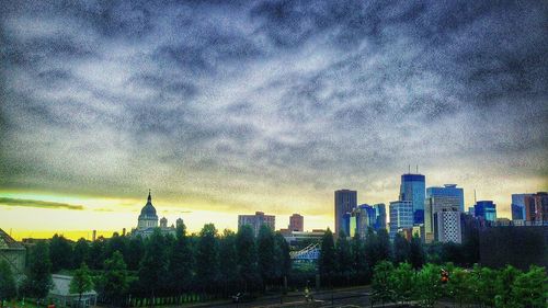 Skyscrapers against cloudy sky