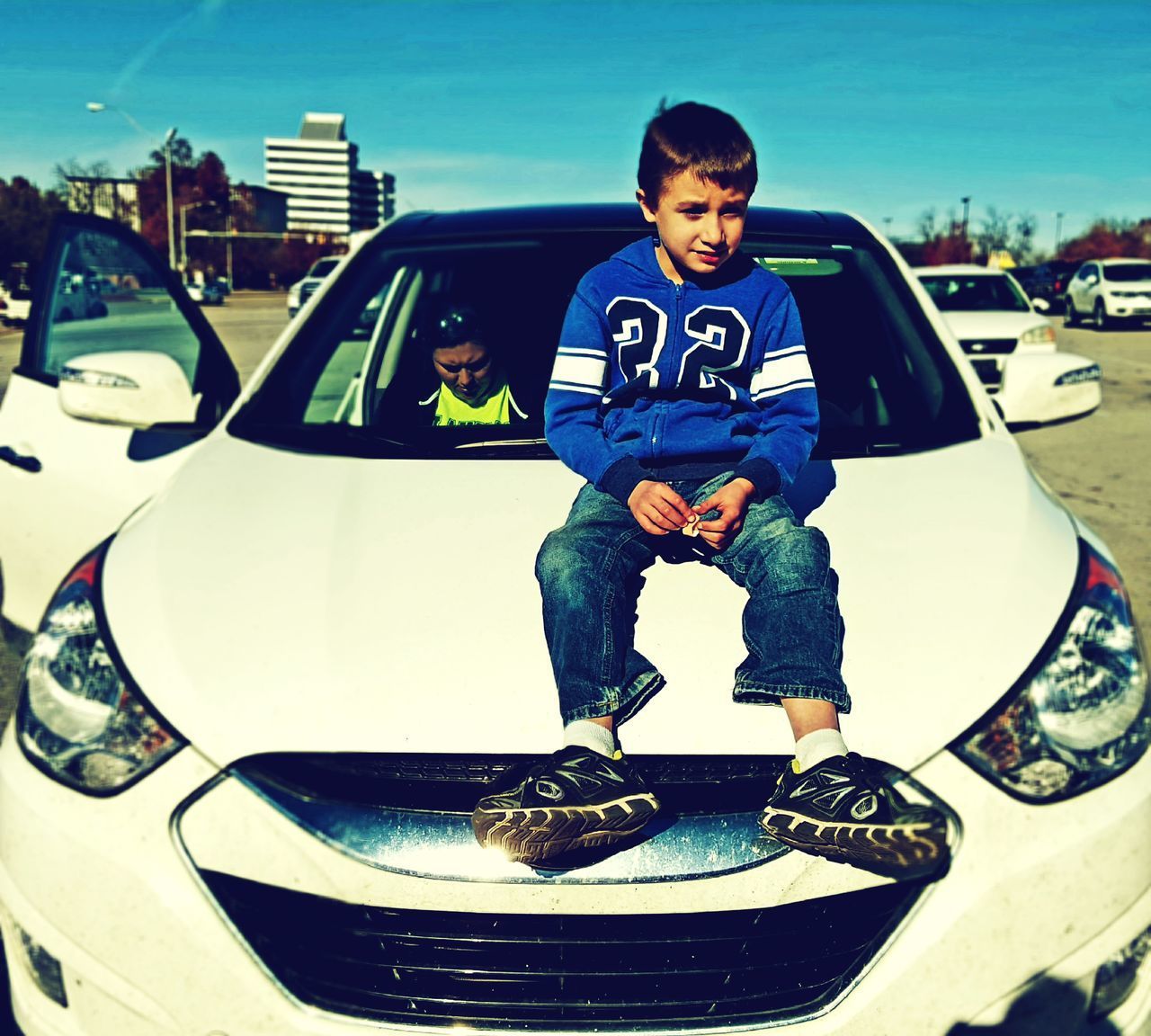 PORTRAIT OF BOY STANDING AGAINST SKY