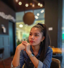 Portrait of a young woman looking away