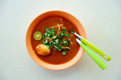 Close-up overhead view of food on white surface