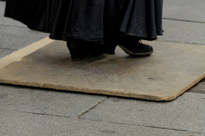 Low section of woman standing on tiled floor