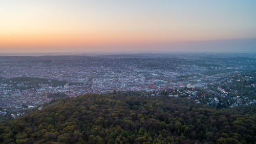 Aerial view of cityscape against sky at sunset