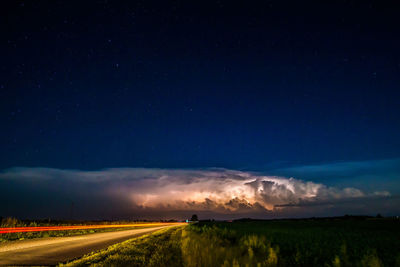 Scenic view of field against sky at night