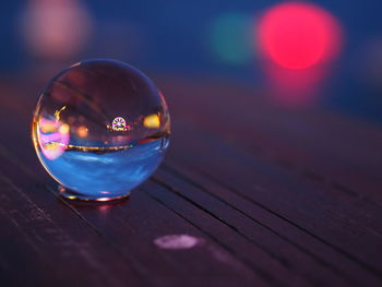 Close-up of crystal ball on glass table