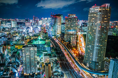 High angle view of illuminated buildings in city at night