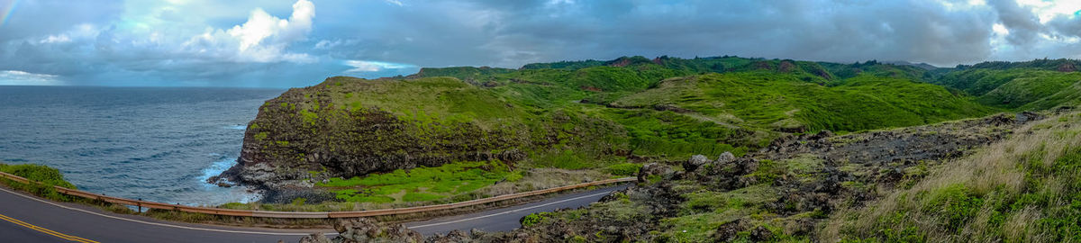 Panoramic view of road by sea against sky