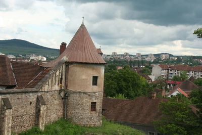 Buildings in town against sky