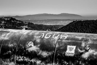 Information sign on mountain against sky