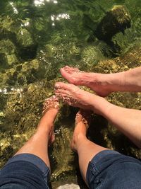 Low section of two people in water