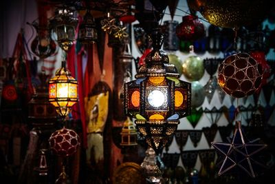 Low angle view of illuminated lighting equipment hanging on tree