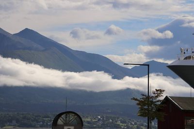 Scenic view of mountains and buildings against sky