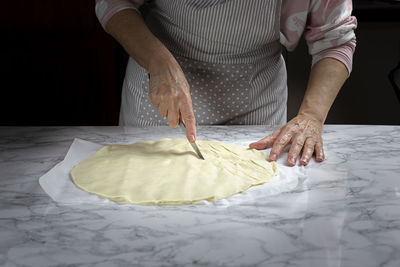 Midsection of man holding dough