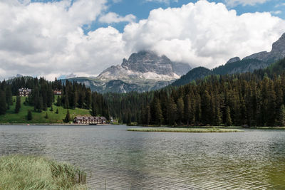 Scenic view of lake by trees against sky