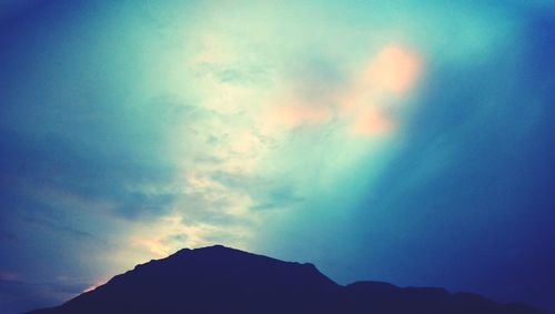 Low angle view of silhouette mountain against sky