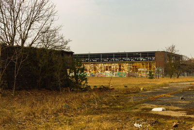 Abandoned building on field against clear sky