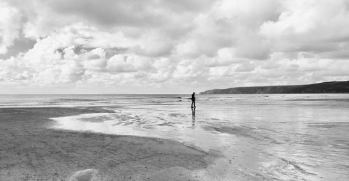 A person walking alone on the beach 