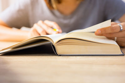 Close-up of woman reading book