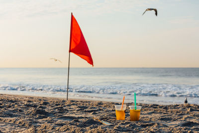 Scenic view of beach against sky during sunset with drinks