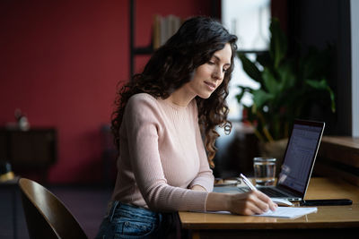 Young businesswoman prepare for financial report presentation and sales result make note in notebook