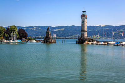 Scenic view of sea by buildings against sky