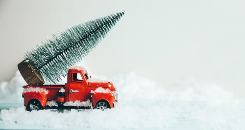 Red toy car on snow covered land