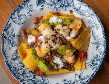 High angle view of nachos mexican food in plate on table