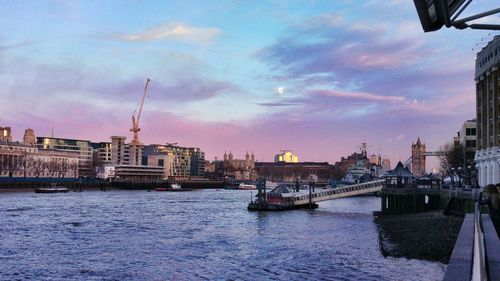 View of city at waterfront during sunset