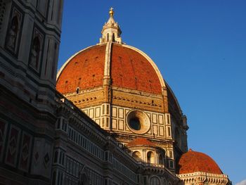 Low angle view of duomo santa maria del fiore against clear blue sky