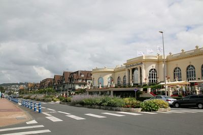 Buildings against cloudy sky