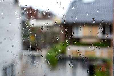 Full frame shot of wet glass window in rainy season