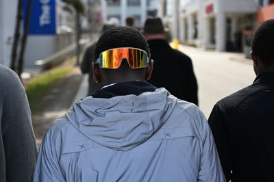 Rear view of man standing in city