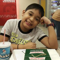 Portrait of smiling boy holding indoors