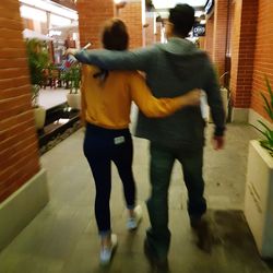 Rear view of people walking in city