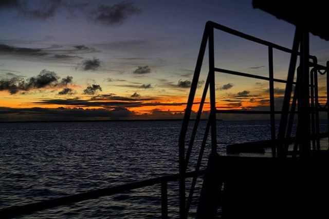 sunset, water, sea, orange color, sky, scenics, beauty in nature, tranquility, tranquil scene, silhouette, pier, horizon over water, nature, railing, cloud - sky, idyllic, built structure, rippled, cloud, nautical vessel